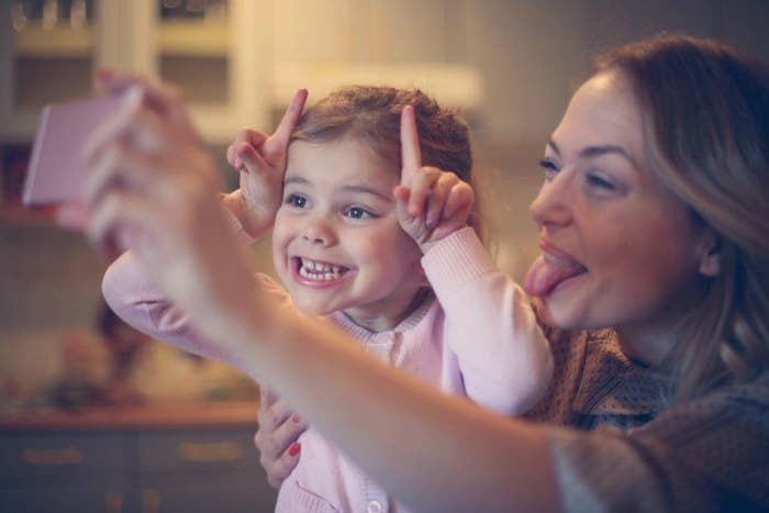 Mom and daughter taking a silly selfie