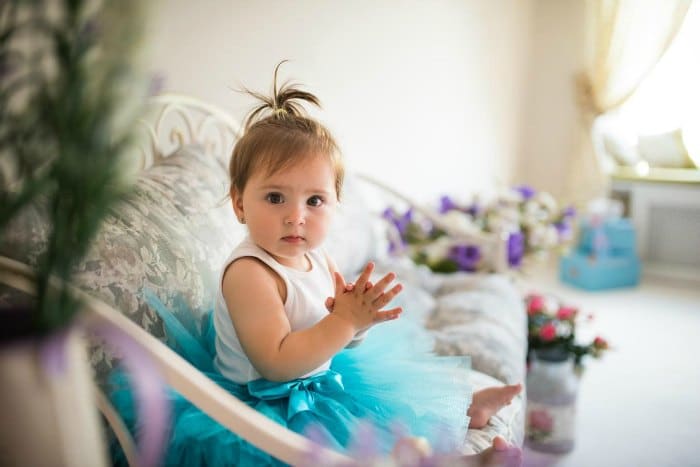 Girl in a blue dress on a couch