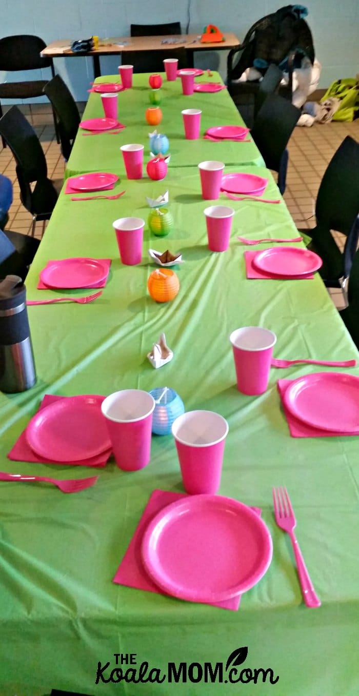 birthday party table decorated with pink paper plates