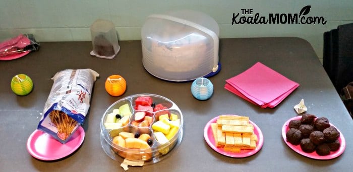 Birthday party snacks - fruit tray, chocolate muffins, prezels, cake.