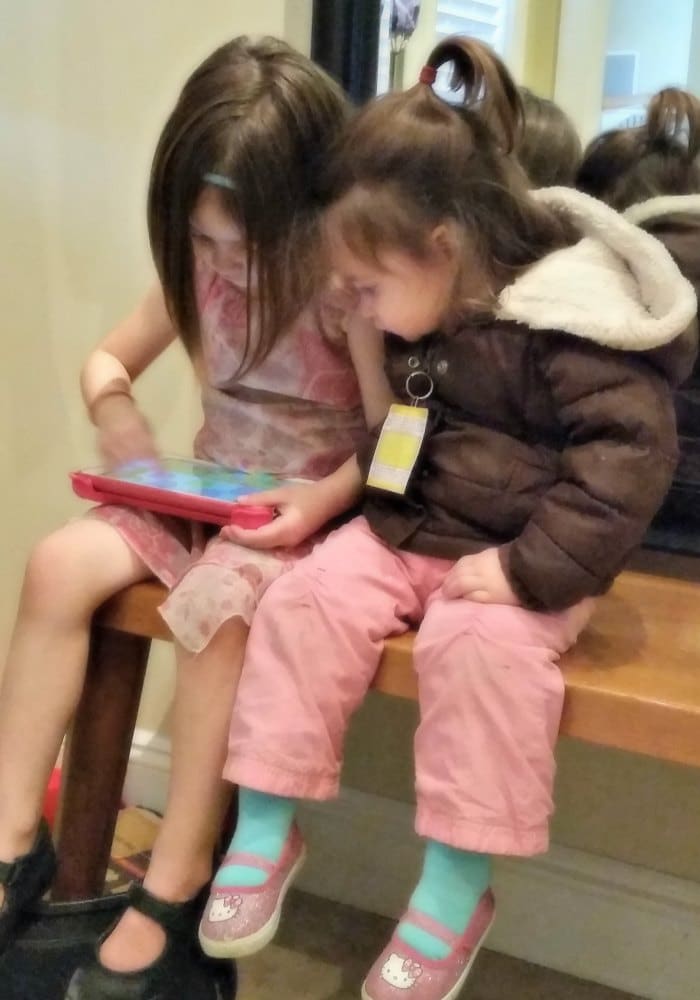 Jade (4) and Pearl (2) playing together on my tablet while we're waiting for big sister's music lessons.