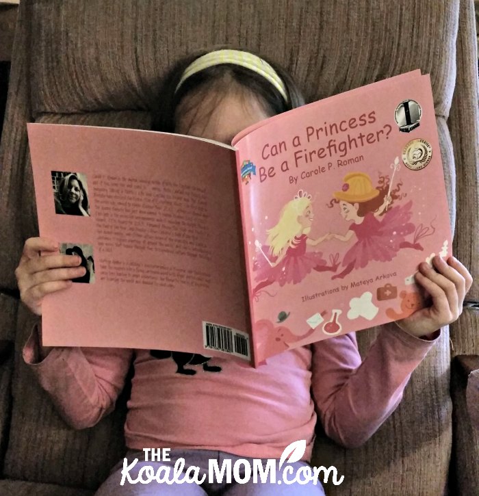 Girl reading Can a Princess Be a Firefighter by Carole P. Roman
