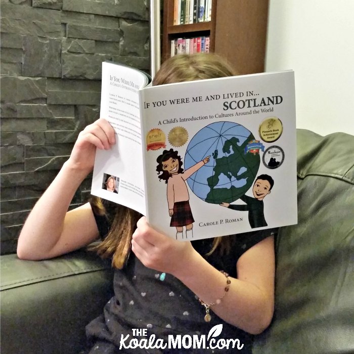Girl reading If You Were Me and Lived in... Scotland: a Child's Introduction to Cultures Around the World by Carole P. Roman