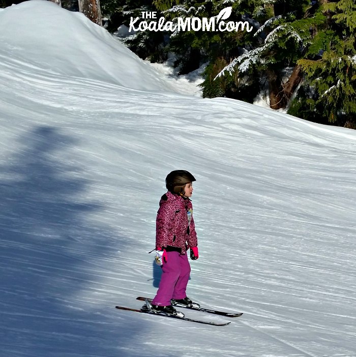 7-year-old Lily skiing down the hill.