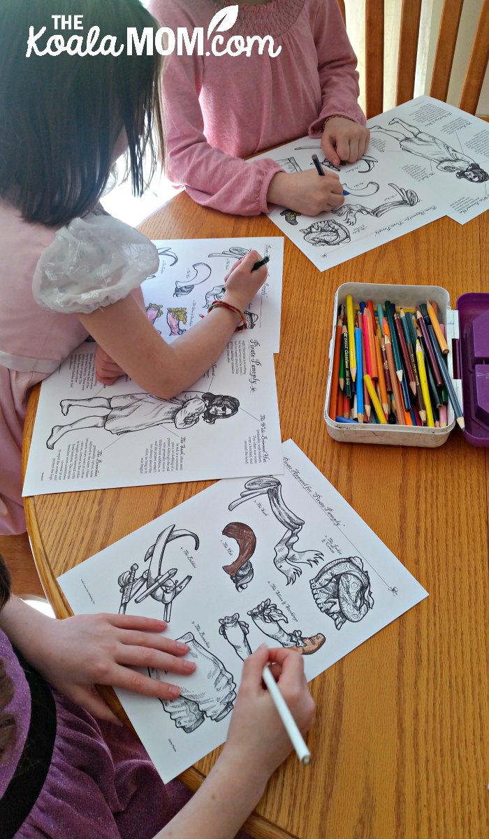 Girls colouring their pirate clothes for the Pirate Panoply game from Homeschool in the Woods