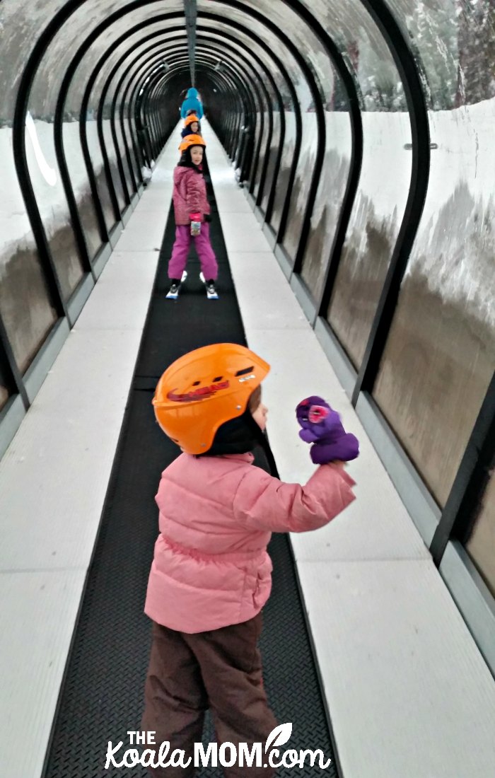 My three girls riding the magic carpet at the ski hill.