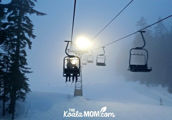 Riding the chairlift at the ski hill at night.