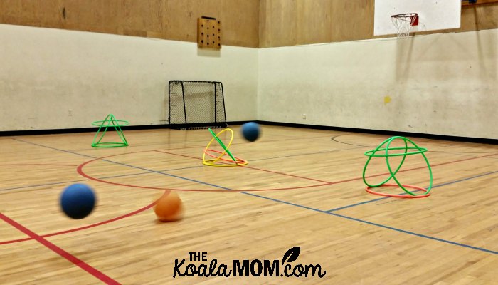 Balls bouncing toward hula hoops during one of the Sportball kids sports classes.