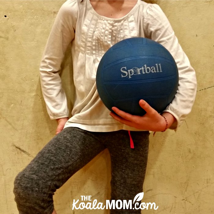 Girl holding a Sportball volleyball.