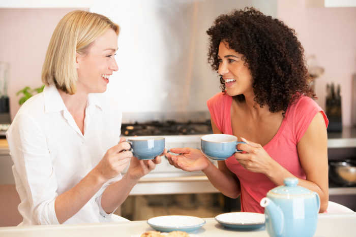 Two moms having coffee together. Photo via Depositphotos.