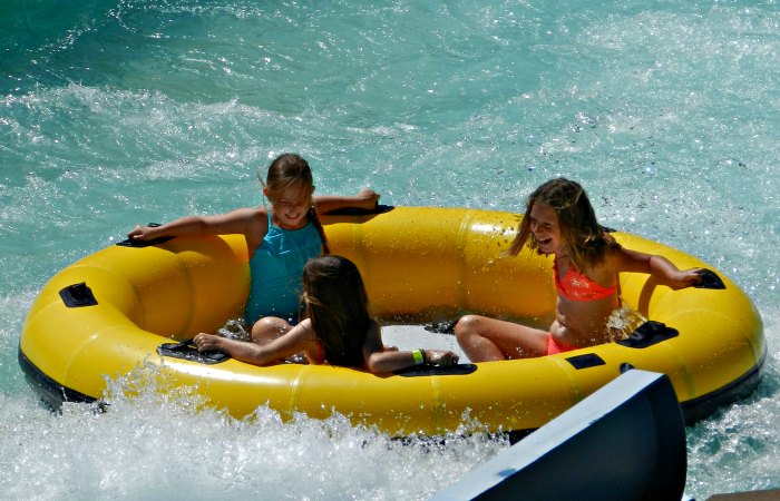 Girls riding a raft down Colossal Canyon at Cultus Lake Waterpark.