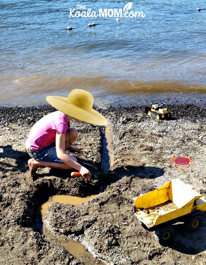 8-year-old playing in the sand at Cultus Lake Beach.