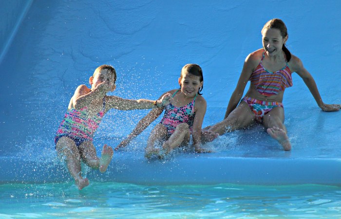 Kids sliding into a pool at Cultus Lake Waterpark.
