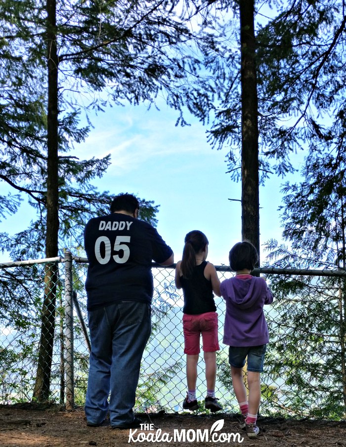 Daddy and two daughters standing at the Teapot Hill Trail lookout.