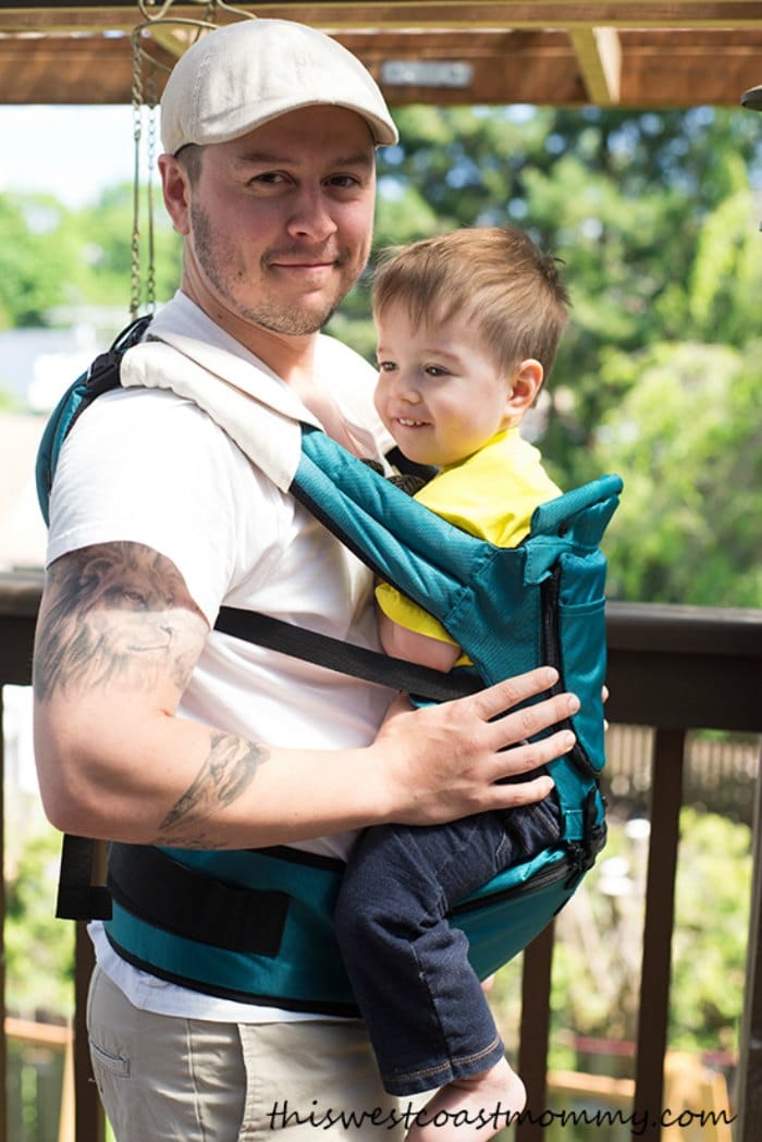 Dad using a MiaMily Hipster Baby Carrier to carry his toddler son