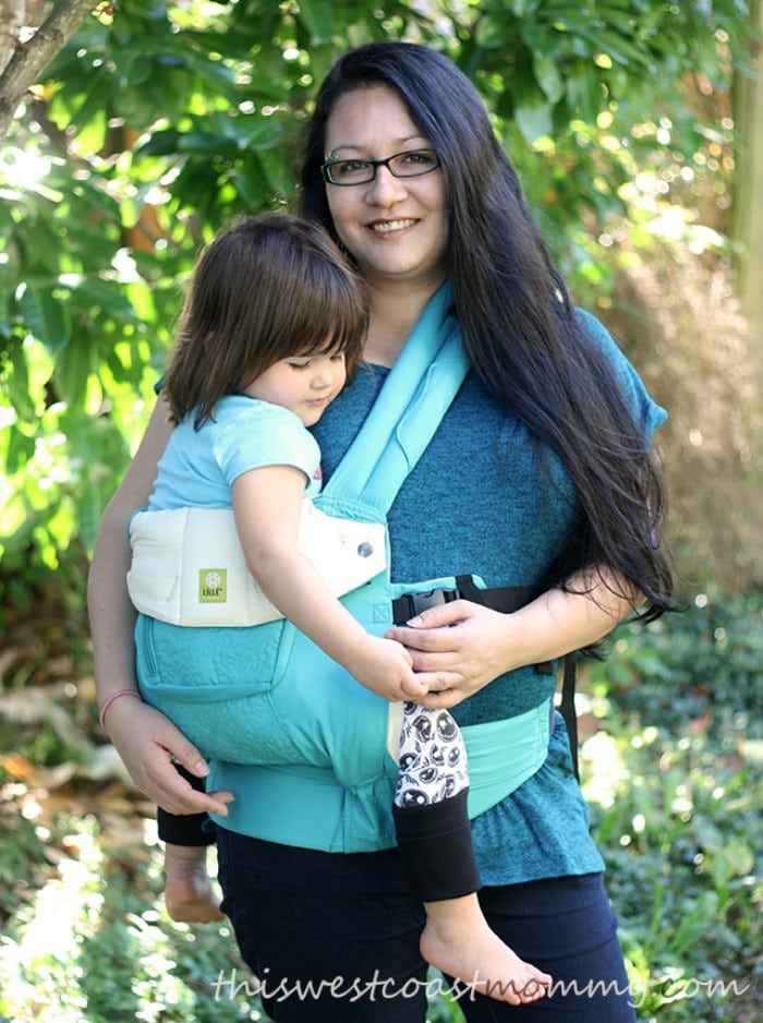 Olivia carries her three-year-old in a LILLEbaby Complete Carrier hip carry