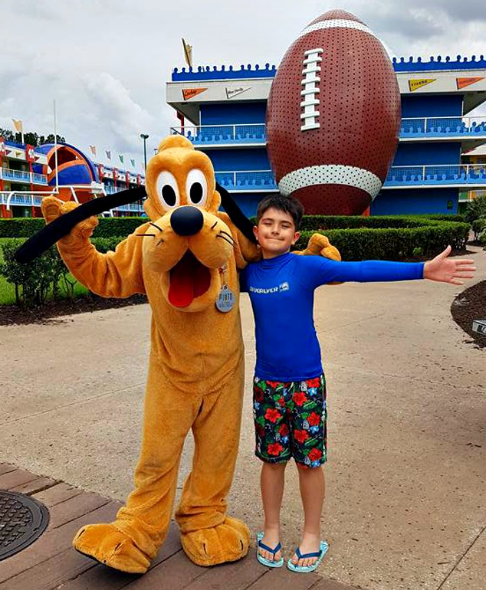 Boy hugging Goofy at Walt Disney World Resort