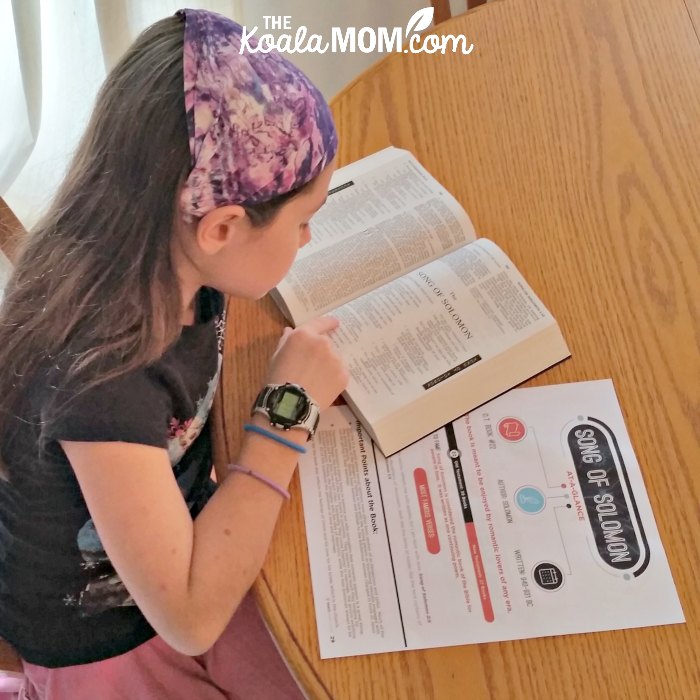 Sunshine reading her Bible with a printable reference sheet from Teaching Sunday School.