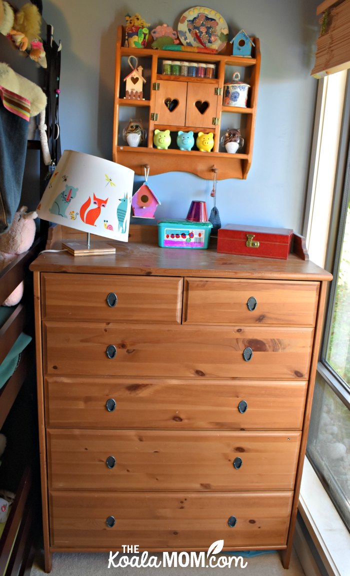 Ikea dresser with a kids' lamp on top.