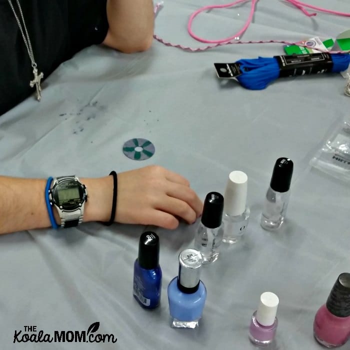 Making saint medals with washers and nail polish at our Canadian Catholic All Saints Day Party.