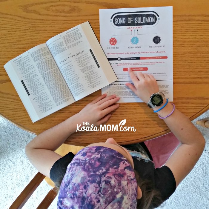 Sunshine (age 10) using the Books of the Bible at-a-glance printables while reading her Bible.