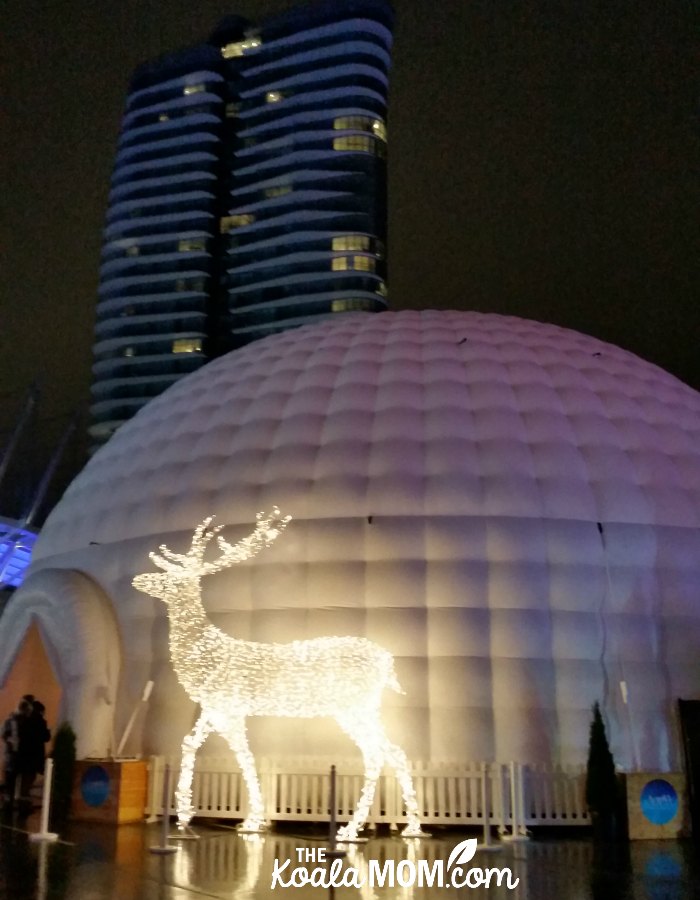 Beautiful white elk light statue in front of Santa's igloo at the Aurora Winter Festival in downtown Vancouver.