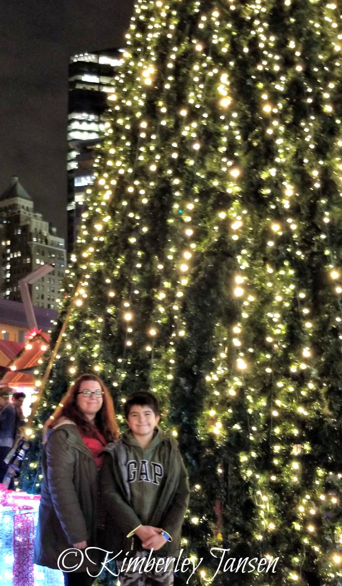 Kimberley and her son post by the giant Christmas tree at the Vancouver Christmas Market on their mother-son date.