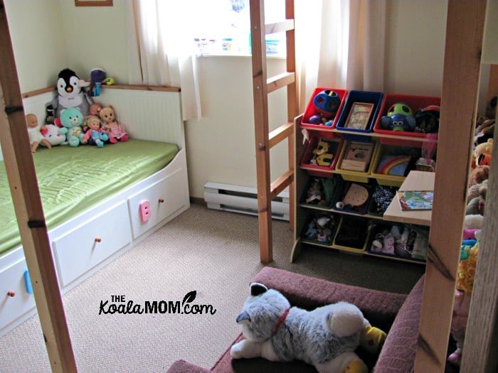 A loft bed saves space in a bedroom by raising the bed off the floor to provide room underneath for other furniture.