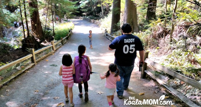 Family hiking the Lighthouse Park Trail in West Vancouver.