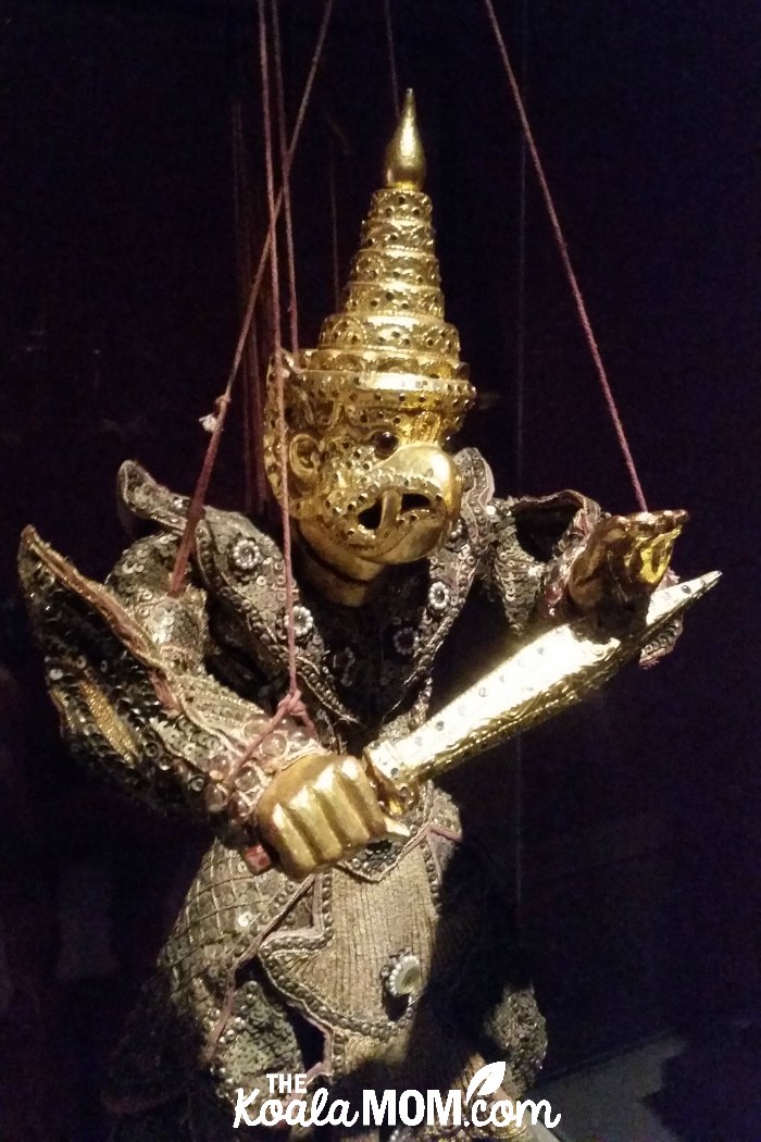 Gold bird warrior string puppet at UBC's MOA.