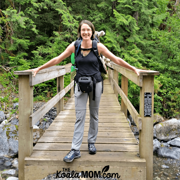 Bonnie Way standing on a bridge on the West Canyon Trail while backpacking in Golden Ears.