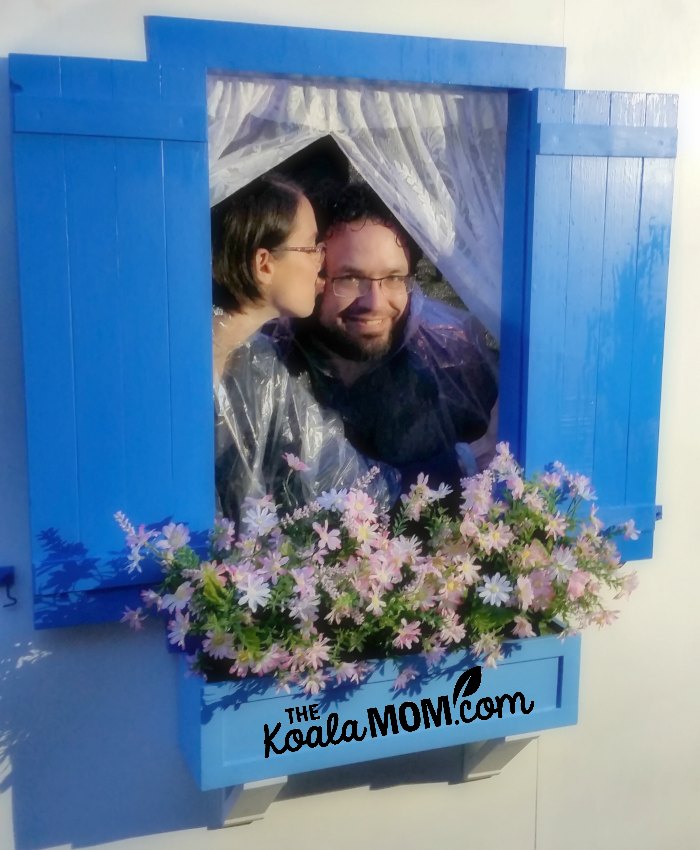 Cute couple kissing in a Mamma Mia-themed photo booth at Theatre Under the Stars in Vancouver.