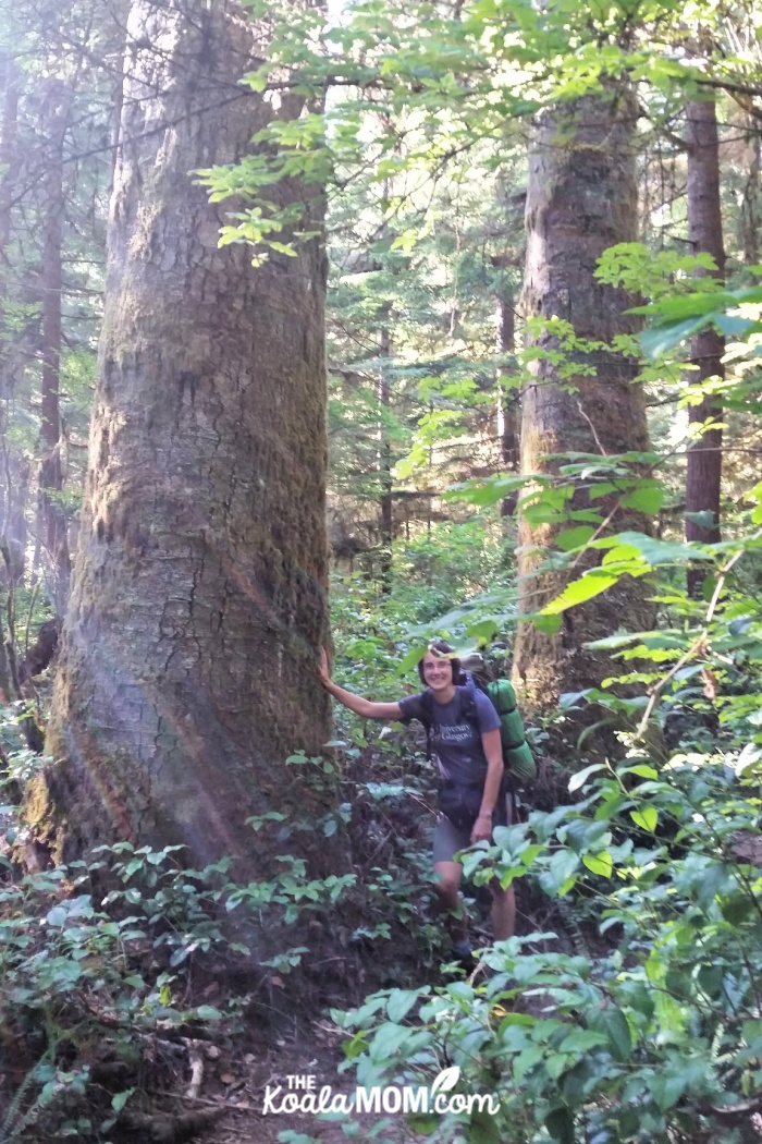 Bonnie Way standing beside a big cedar on the West Coast Trail.
