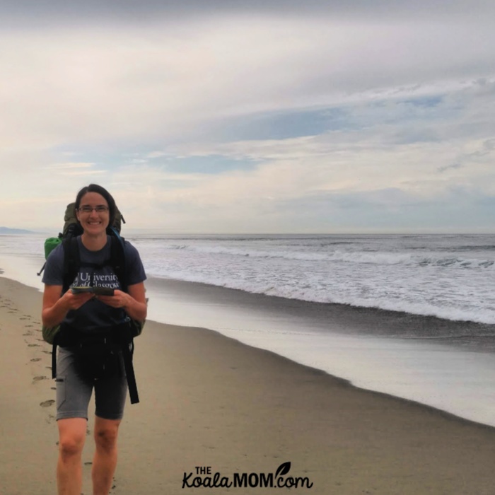 Bonnie Way hiking on the beach with a big smile on her face.