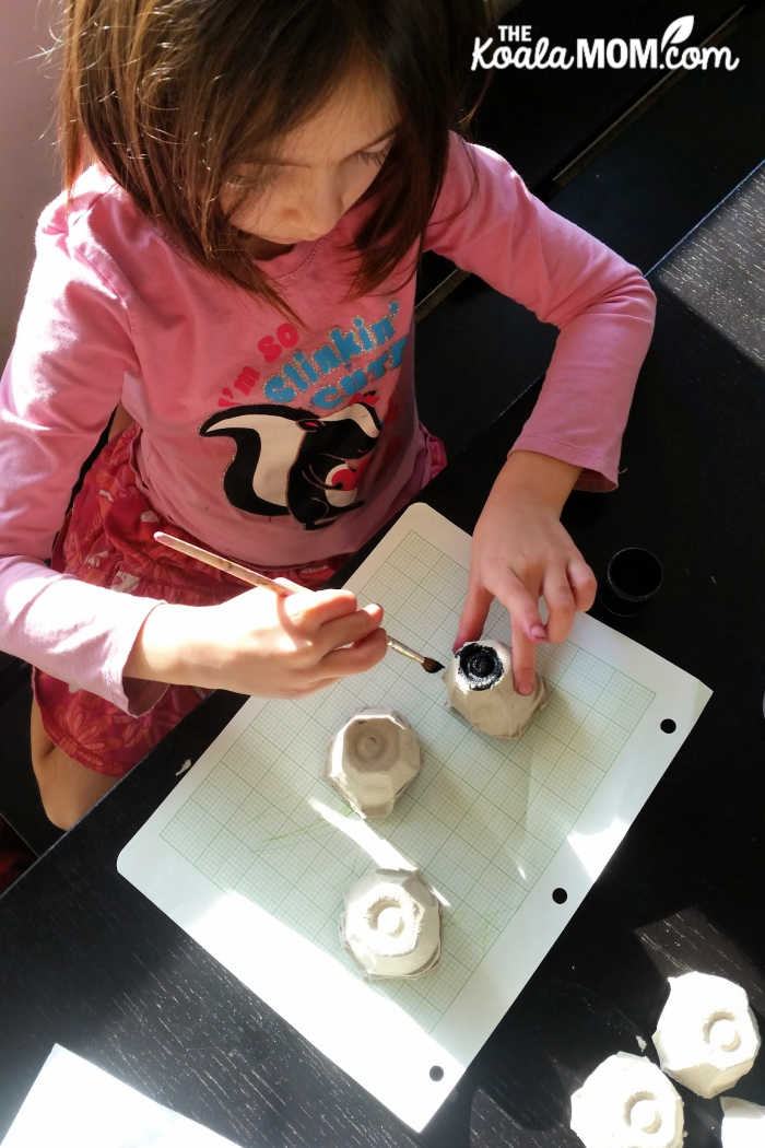 Grade 1 student making an egg carton ant.