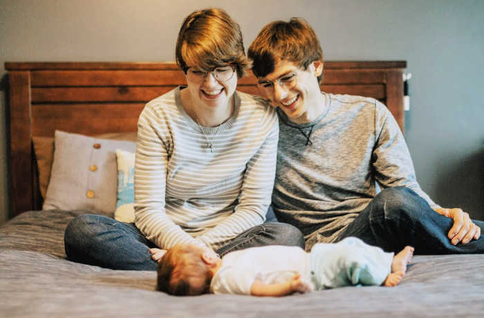 Catholic mom blogger Chloe Langr with her husband and baby daughter