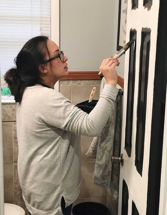 Roxanne from Catholic Homebody, painting a door