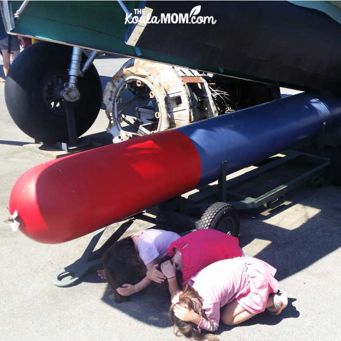 Kids pretending to take cover from a bomb.