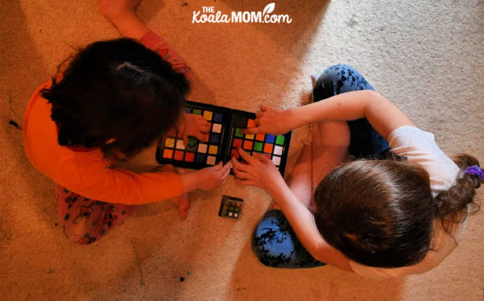 Two sisters playing Rubik's Race.