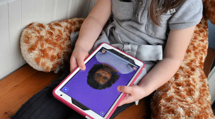 4-year-old Pearl practices new sounds and words with the Speech Blubs app on her tablet.