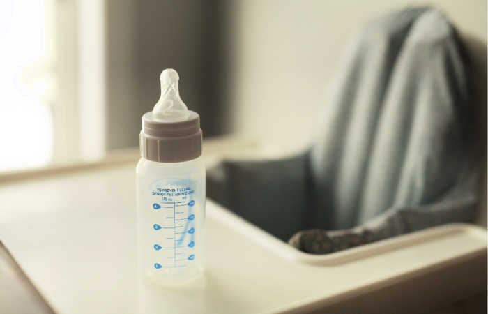 Baby bottle on a high chair.