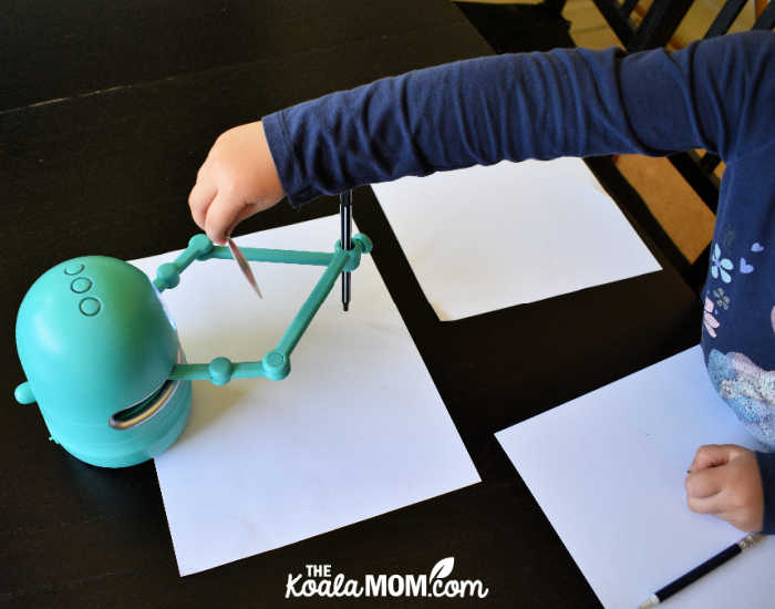 4-year-old using Quincey the Robot Artist to draw a picture.