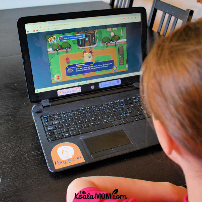 10-year-old playing a Catholic video game on a laptop.