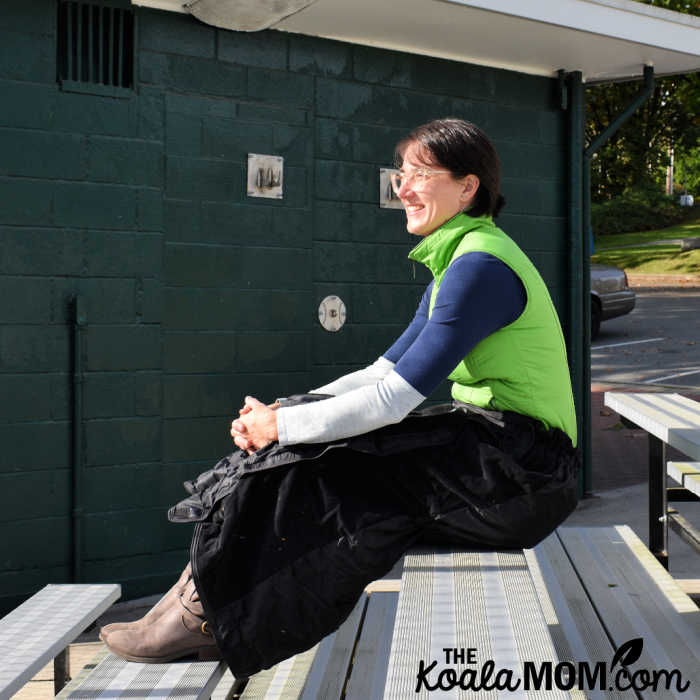 The Mozy is a mobile, cozy blanket that's perfect for watching your kid play sports, like this mom on the bleachers.