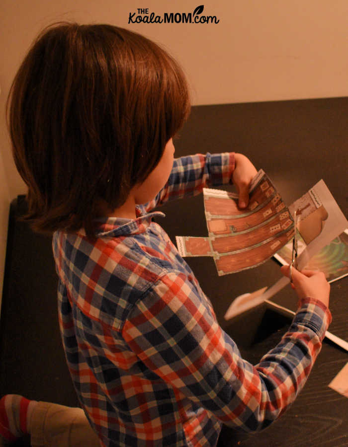 7-year-old Jade cutting out a clue for a kids escape room game.