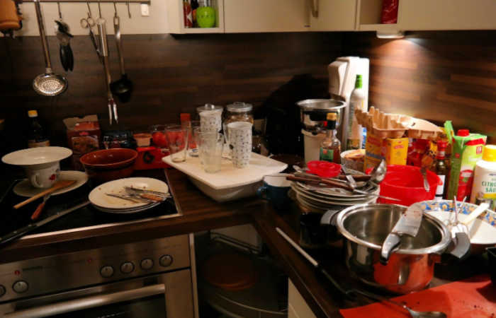 9 Signs That You're Living in a Cluttered Home - there are dirty dishes everywhere, like this cluttered kitchen.