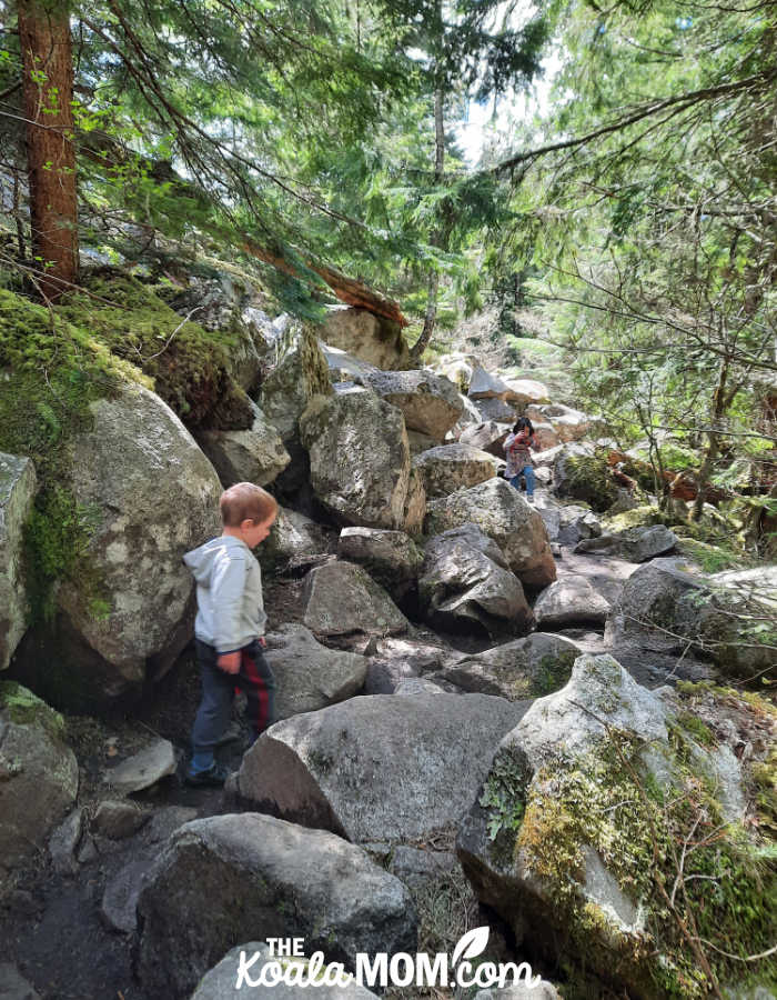 A 5-year-old and a 3-year-old pick their way over the trail through the boulder field on the Lindemann Lake Trail.