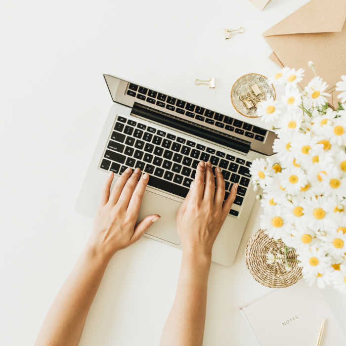 Woman working on her blog on a laptop.