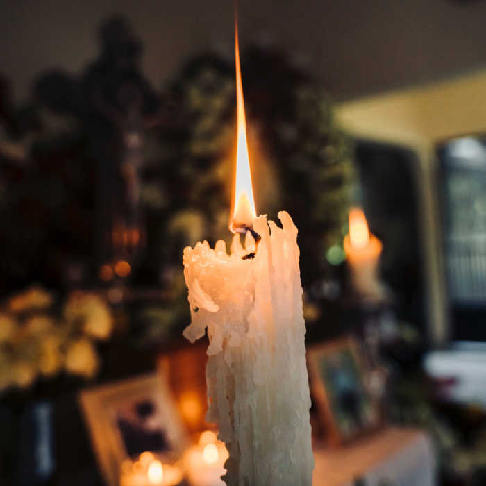 Candle burning at a memorial service.