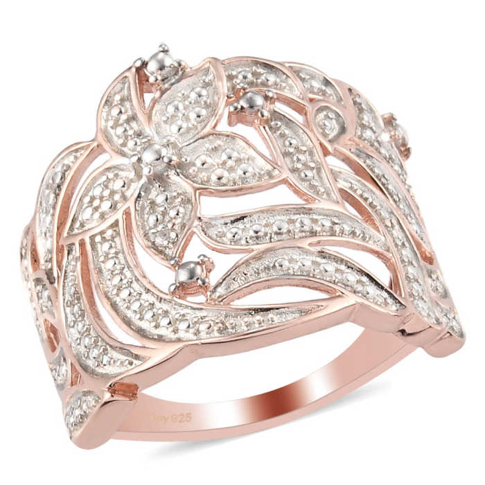 Dainty rose gold ring with diamonds and a flower design on top.